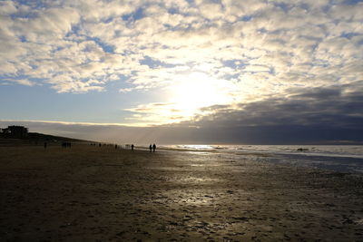 Scenic view of beach against sky during sunset