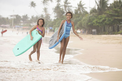 Portrait of happy friends on beach