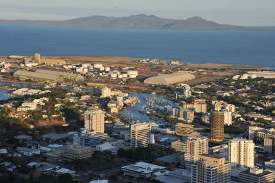 High angle view of buildings and sea against sky