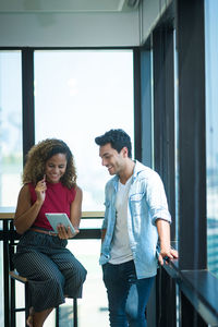 Young couple standing on mobile phone