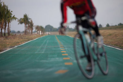 Man riding bicycle on road