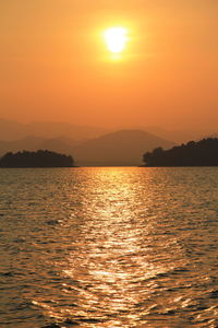 Scenic view of sea against orange sky