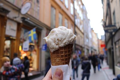 Close-up of hand holding ice cream cone