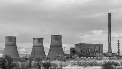 Thermal coal power plant chimney blue sky black and white