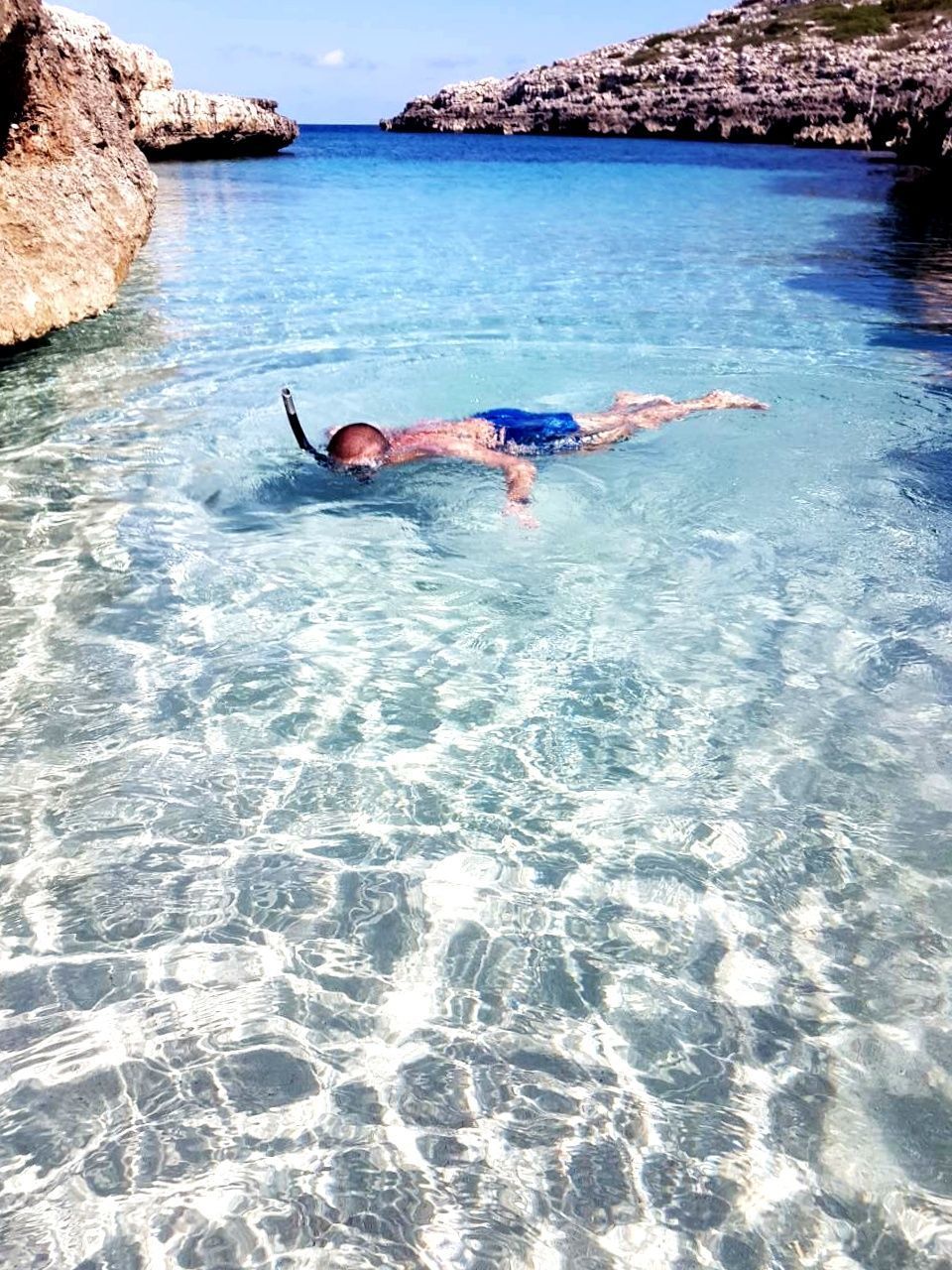 MAN SWIMMING IN THE SEA