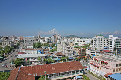 High angle view of buildings against clear blue sky