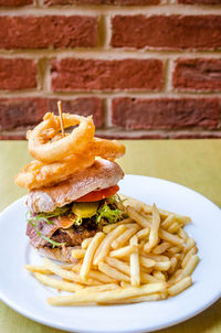 Close-up of burger and fries in plate