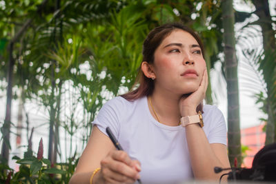 Portrait of young woman looking away