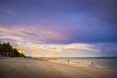 Scenic view of beach against sky during sunset