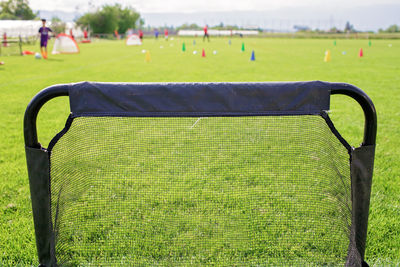 Soccer gears on green grass prepared for training in kids football academy. popular sport activity