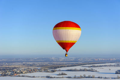 Hot air balloon flying against blue sky