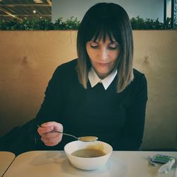 Woman having food at home