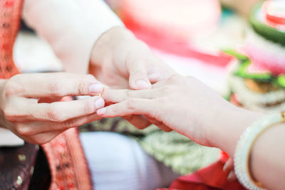 Midsection of couple holding hands