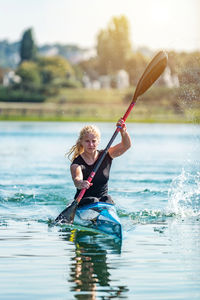 Full length of man jumping on lake