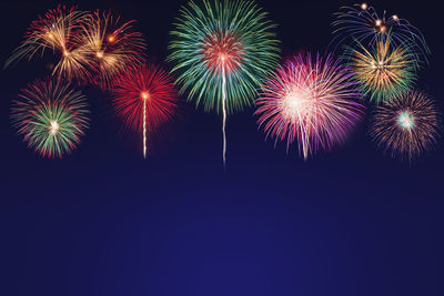 Low angle view of firework display at night