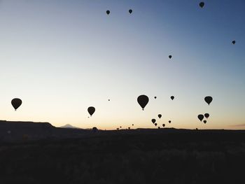 Hot air balloons flying in sky during sunset