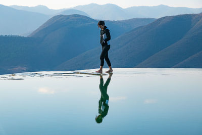 Man standing on mountain against sky