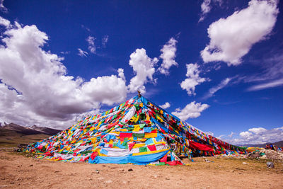 Multi colored tibet prayer flags on ground against sky