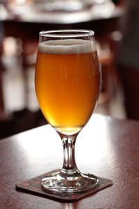 Close-up of beer glass on table