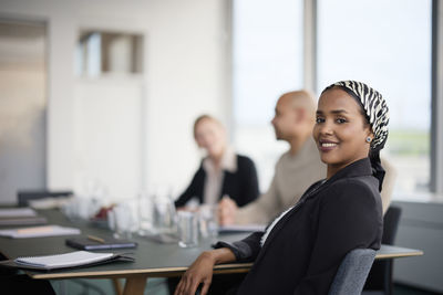 Smiling woman at business meeting