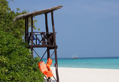 Lifeguard hut on beach against sky