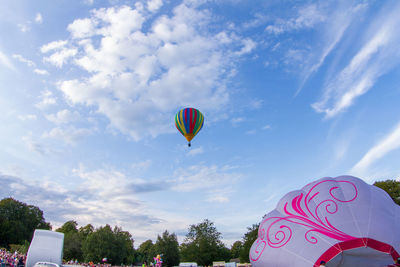 Low angle view of balloons flying against sky