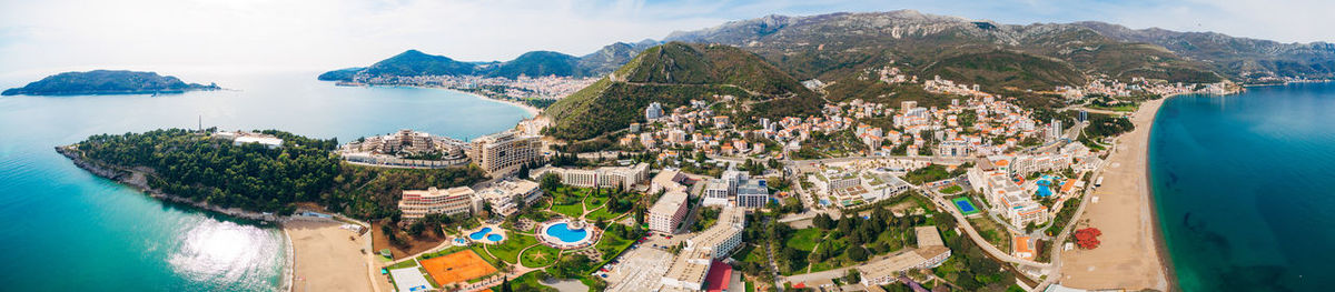 High angle view of buildings and sea against sky