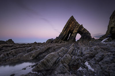 The imposing blackchurch rock on mouthmill beach in devon at sunset