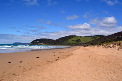 Scenic view of beach against blue sky