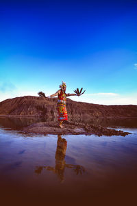 Reflection of person standing in water