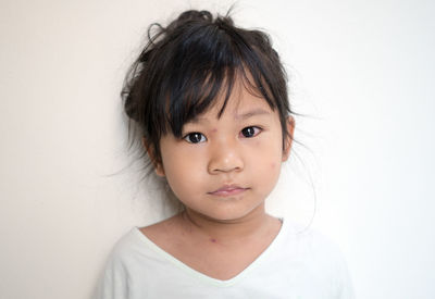 Portrait of cute girl against white background