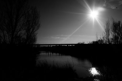 Bridge over river at sunset