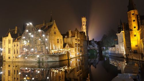 Panoramic view of illuminated buildings against sky at night