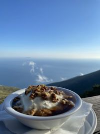 Close-up of food in sea against sky