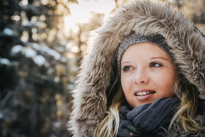 Portrait of smiling young woman during winter