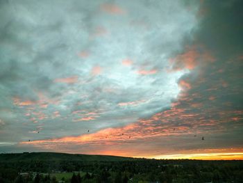 Scenic view of landscape against dramatic sky