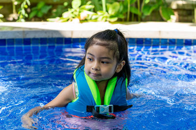 Portrait of cute girl in swimming pool