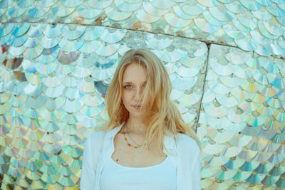 Portrait of young woman standing against decorations