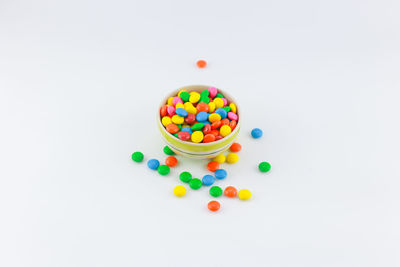 Multi colored candies against white background