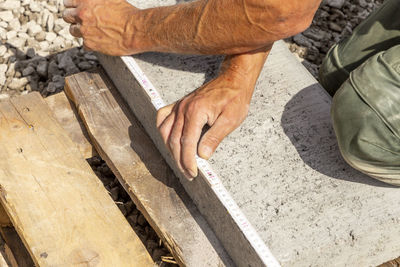 Low section of man working on wood