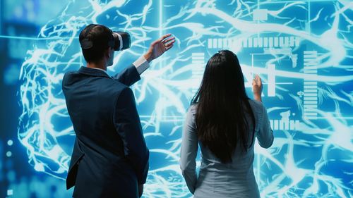 Rear view of woman looking at aquarium