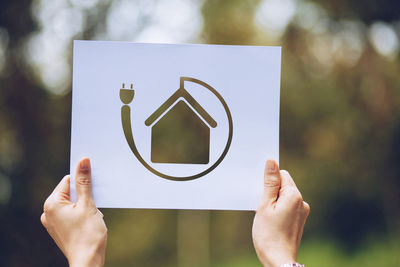 Midsection of person holding paper