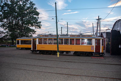 Train on railroad track in city against sky