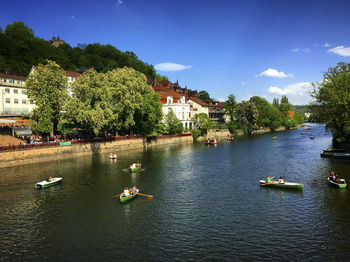 Scenic view of river against sky in city