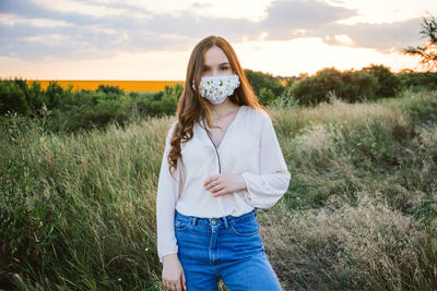 Statement masks, blinged out diy flower face mask design. girl in face mask decorated with flowers 