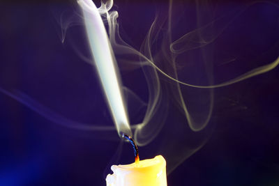 Close-up of lit candles on black background