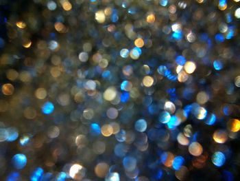 Defocused image of illuminated christmas tree against sky