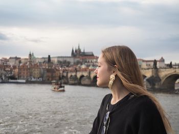 Portrait of woman with city in background