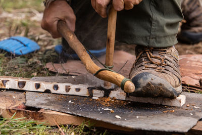 Low section of man working on wood