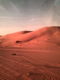 Scenic view of desert against sky during sunset